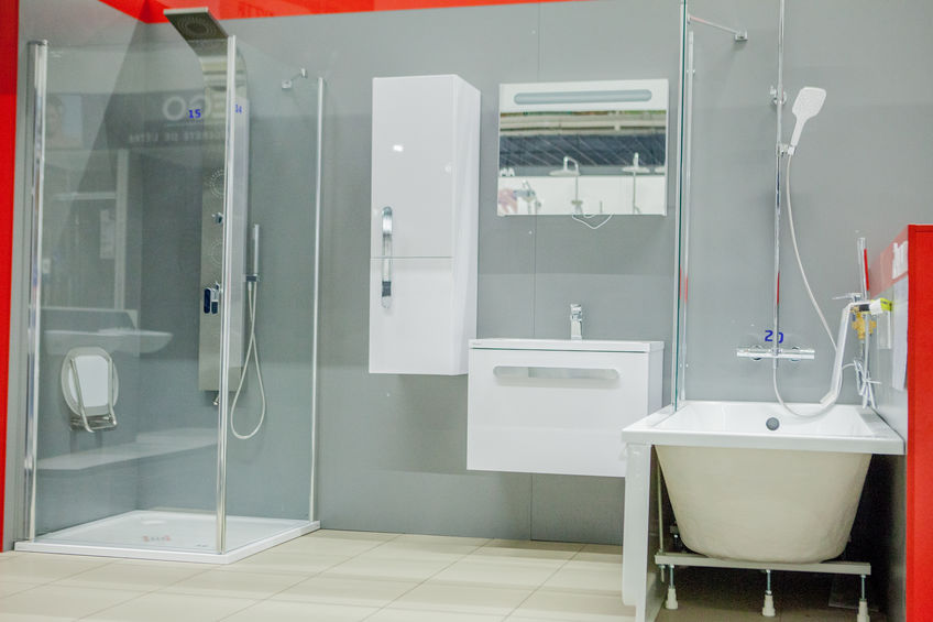 Spacious bathroom in gray tones with freestanding tub, walk-in shower, double sink vanity.
