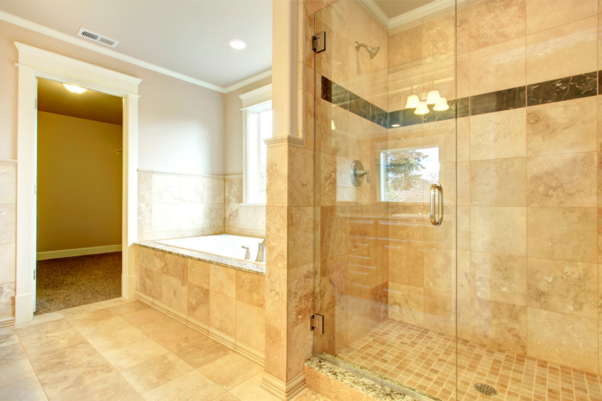 Cozy bathroom with tub and glass door shower