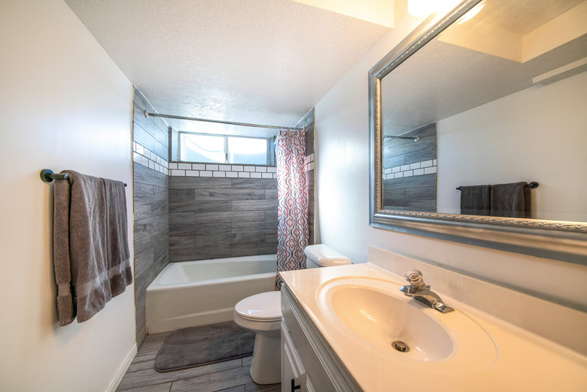Bathroom interior with window and vinyl wood tiles.