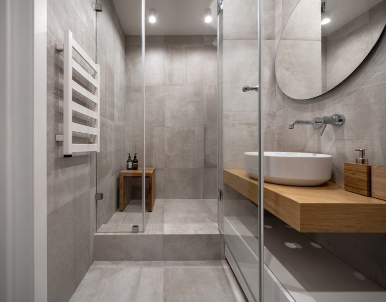 Stylish modern bathroom with light tiled walls and floor