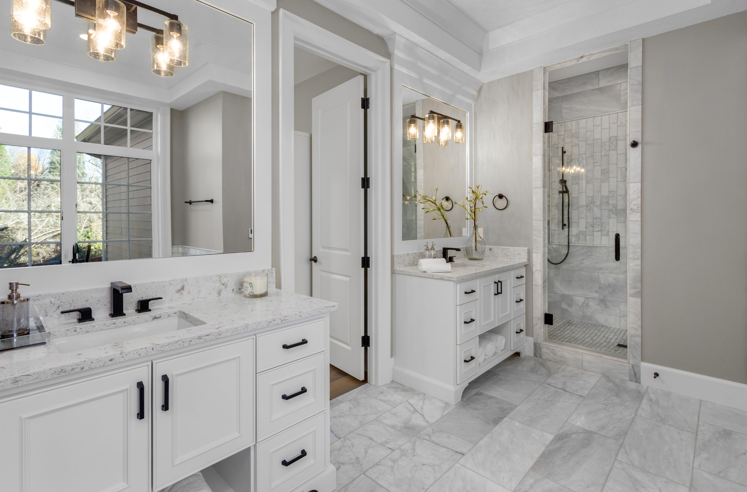 Beautiful bathroom in new luxury home with two vanities, sinks,