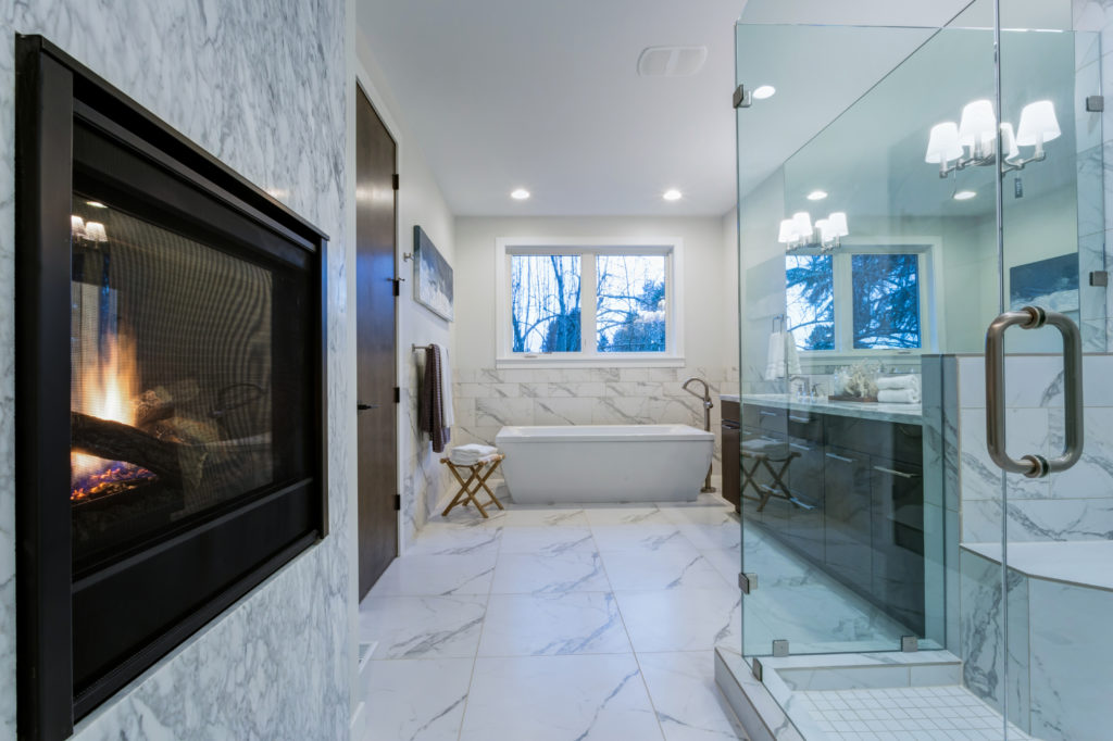 Incredible marble bathroom with fireplace.